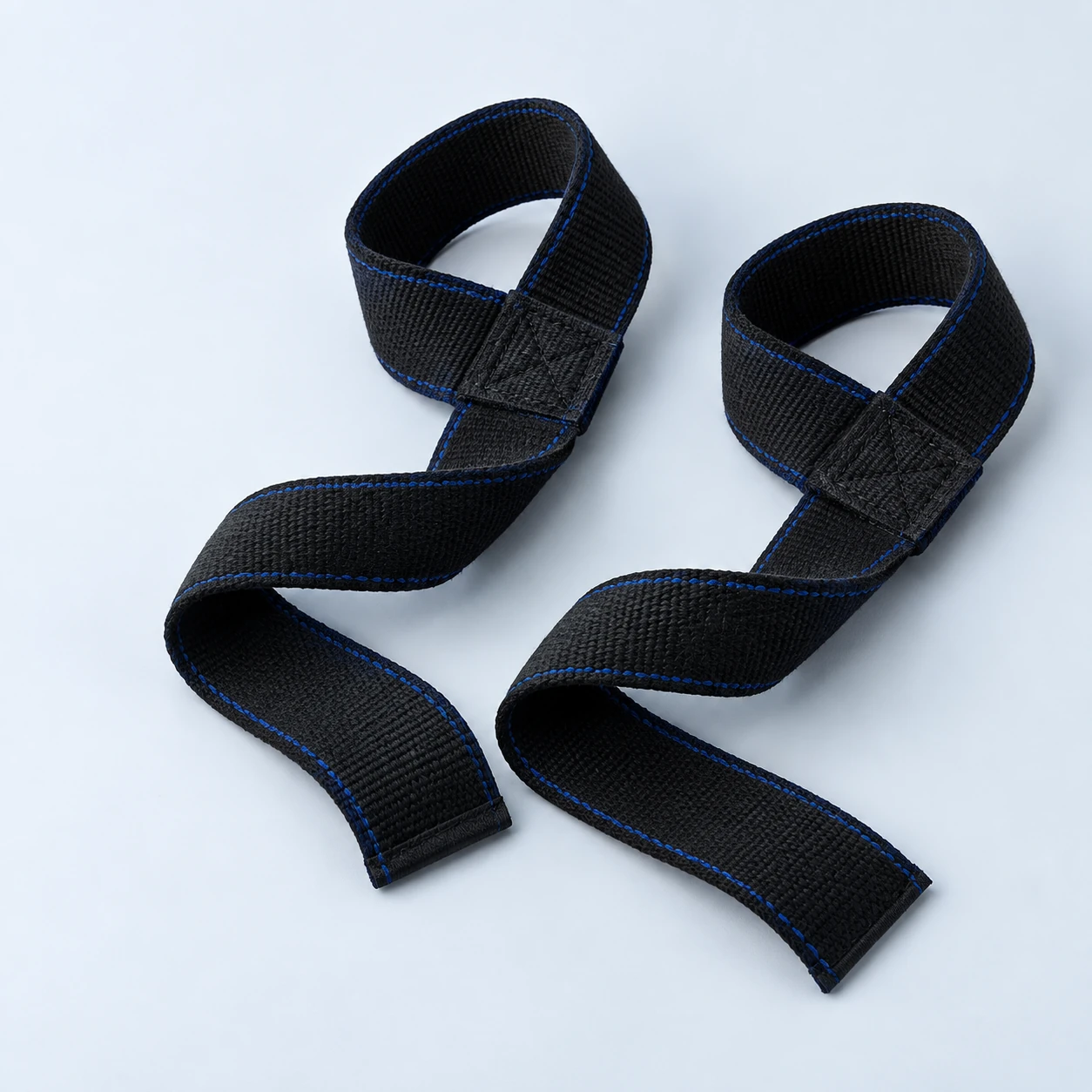 Pair of black woven lifting straps with cobalt stitching